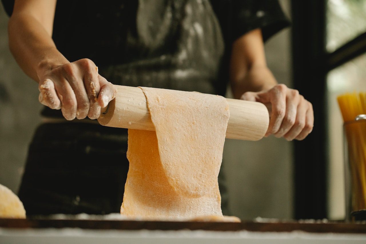 Pizza dough over rolling pin
